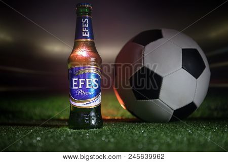 Baku,azerbaijan - June 15, 2018 : Bottle Of Efes Pilsner Beer On Grass With Soccer Ball And Blurred