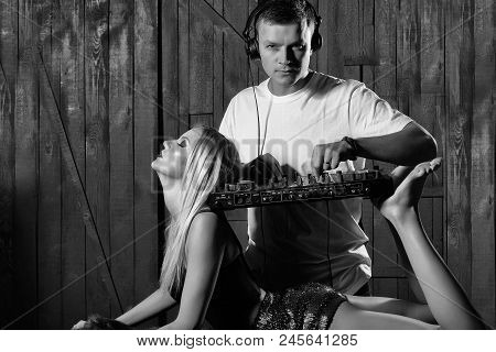 Musical Party. Young Man Musician In White Shirt With Headset Playing Dj Mixer Equipment Standing On