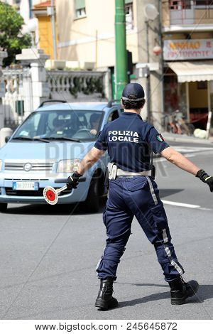 San Remo, Italy - June 10, 2018: Italian Policeman (polizia Locale) In Uniform Controlling Road Traf