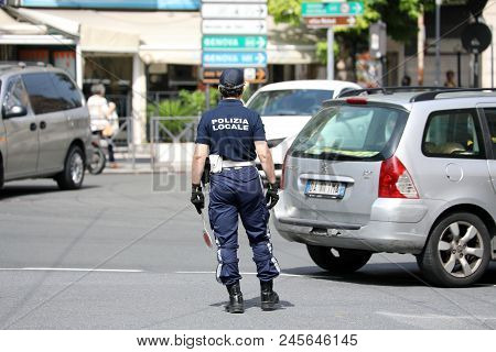 San Remo, Italy - June 10, 2018: Italian Policeman (polizia Locale) In Uniform Controlling Road Traf