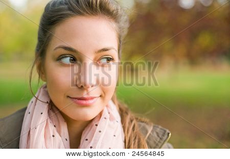Portrait Of Beautiful Young Brunette Outdoors, Taking A Sideways Glance.