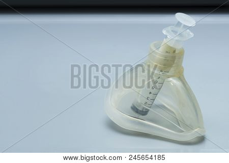 Ambu Mask And Plastic Syringe On The Anesthesiologist Desk In Operating Room