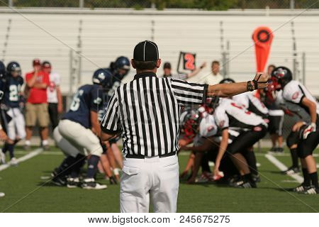 Youth Football Referee Ready For The Next Play.