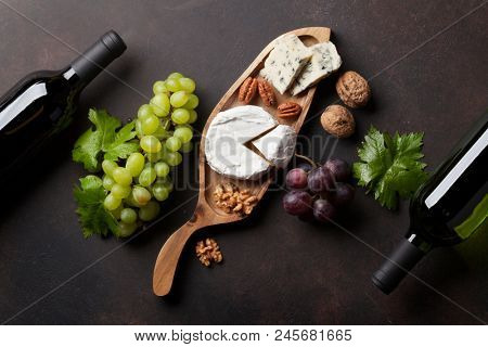 Wine, cheese, grape and nuts. Top view