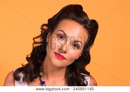 Beautiful Brunette With Hairdo And Make Up In Studio, Pin Up Style, Close Up Portrait