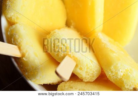 Yellow Pineapple Ice Lollies Grouped In White Bowl Overhead Closeup