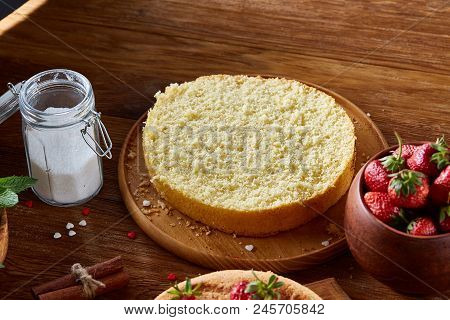Top View Raw Ingredients For Cooking Strawberry Pie Or Cake On Wooden Table: Eggs, Sugar And Strawbe