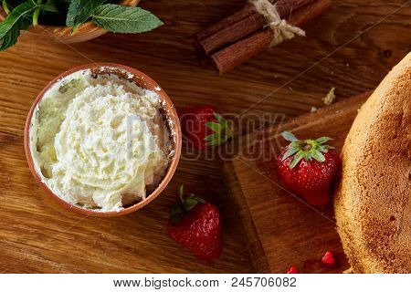 Top View Raw Ingredients For Cooking Strawberry Pie Or Cake On Wooden Table: Eggs, Sugar And Strawbe