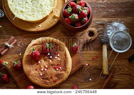 Top View Raw Ingredients For Cooking Strawberry Pie Or Cake On Wooden Table: Eggs, Sugar And Strawbe