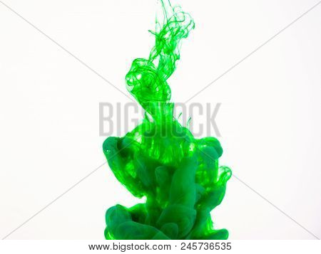 Image Of Green Paint Dissolving Into Water. Deteiled Photo Of Green Paint Dropped Into Liquid, Abstr
