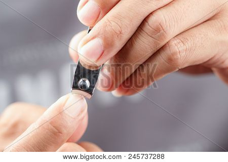 Close Up Shot Of Man Cutting Nails