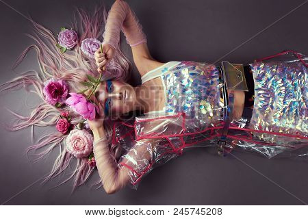 Gorgeous Woman In Biofuture Pompadour Style. Female In Fashion Transparent Raincoat With Splendid Ma