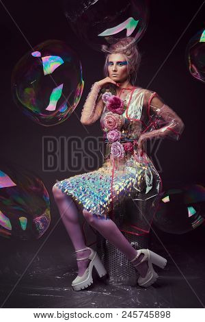 Gorgeous Woman In Biofuture Pompadour Style. Female In Fashion Transparent Raincoat With Splendid Ma