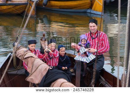 Urk, Netherlands - May 19, 2018: Unknown Man And Children In Traditional Costumes On The Urkerdays. 