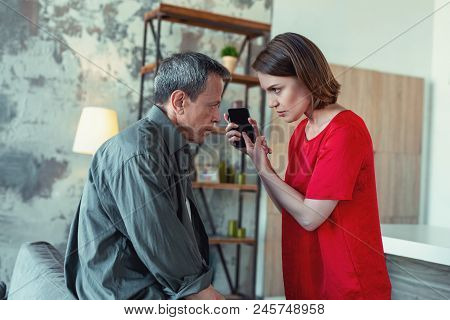 Reading Messages. Furious Young Wife Feeling Extremely Angry While Reading Messages Of Her Mature Hu
