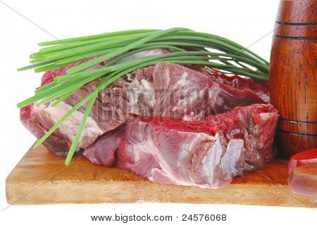 meat portion: bloody beef fillet on plate with cutlery served before cooking