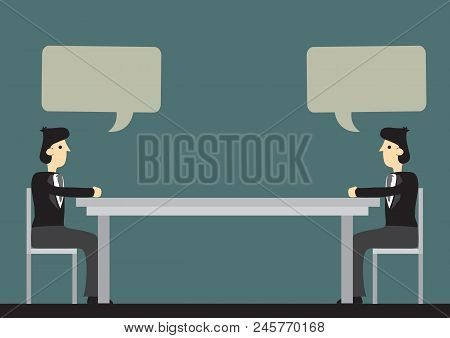 Two Businessmen Sitting At Two Ends Of A Long Table With Blank Speech Balloons For Copy Space. Carto