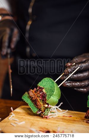 Close Up Of Half Cut Freshly Prepared Green Buns Burger With Meat Cutlet, Cheese, Grilled Onion Marm