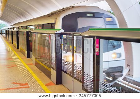 Light Rail Transit Train Arrives At A Station In Singapore. Metro Train Motion Blur