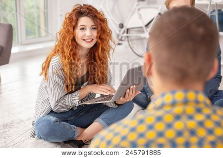 Slower Please. Enthusiastic Female Student Carrying Laptop And Smiling