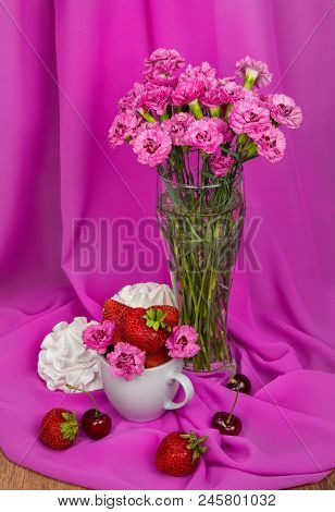 Still-life From A Strawberry, A Sweet Cherry, A Bise And A Bouquet Of Pink Cornflowers On A Backgrou