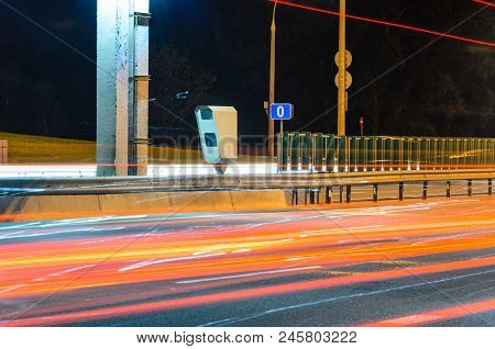 Stationary Car Speed Radar Near A Highway Road. Night Road Traffic Background