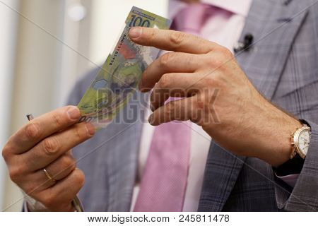 ST. PETERSBURG, RUSSIA - MAY 23, 2018: General director of JSC Goznak Arkady Trachuk shows the commemorative banknote for FIFA World Cup 2018 in the exhibition 