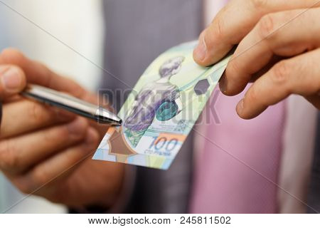 ST. PETERSBURG, RUSSIA - MAY 23, 2018: General director of JSC Goznak Arkady Trachuk shows the commemorative banknote for FIFA World Cup 2018 in the exhibition 