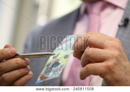 ST. PETERSBURG, RUSSIA - MAY 23, 2018: General director of JSC Goznak Arkady Trachuk shows the commemorative banknote for FIFA World Cup 2018 in the exhibition 