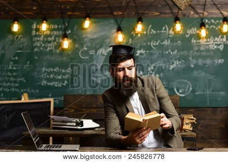 Bearded Man Read Book In Classroom. Scientist Hipster With Book On Chalkboard. Businessman In Suit R