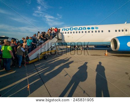 Moscow, Russia - April 19, 2018: Passengers boarding on the aircraft of low cost airline company Pobeda