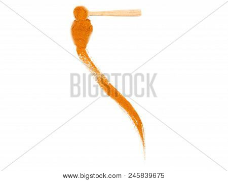A Small Wooden Spoon Full Of Turmeric With Scattered Track Is Lying On The White Background.