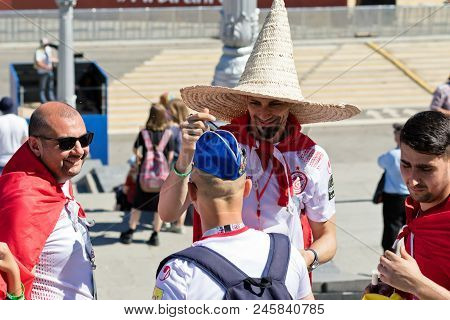 Football Fans Of Tunisia And England Are Changing Their Hats On The Fanfest Before The Match