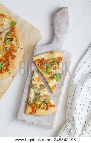 Two Pieces Of White Pizza With Artichoke And Arugula, White Background, Top View