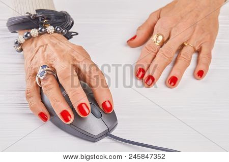 Old Woman Manicured Hand Using Pc Mouse. Close Up Woman Hand With Luxury Rings And Bracelets Operati