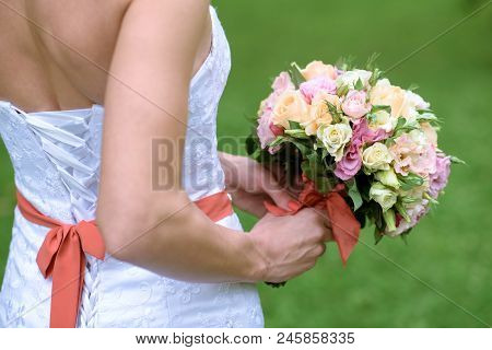 Beautiful Bride Is Holding A Wedding Colorful Bouquet. Beauty Of Colored Flowers. Close-up Bunch Of 