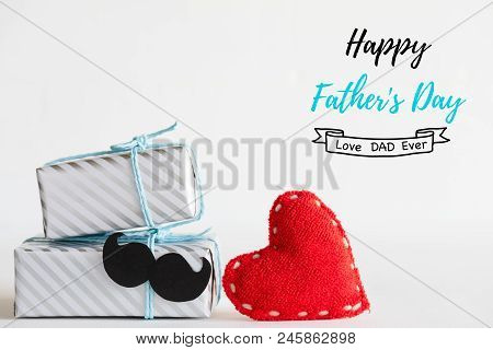 Happy Fathers Day Concept. Stack Of Beautiful Gift Box With Mustache And Handmane Red Heart On White