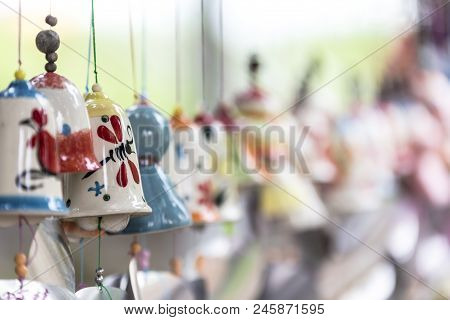 Many Tranditional Wind Chime On Strings In A Row With Bokeh Background
