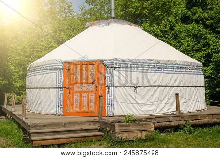 Yurta With National Mongolian Patterns In Summer Sunny Day With Sunny Beams