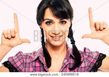 Young Caucasian Brunette Holding A Fake Tv Set Top Box. Promo. White Background Studio Shot. Pink Sh