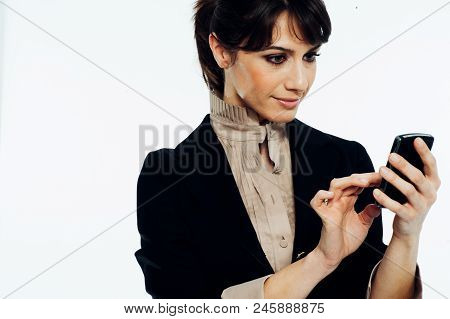 Young Caucasian Brunette Suit Dressed Business Woman Chatting With A Vintage Smartphone. Standing Up