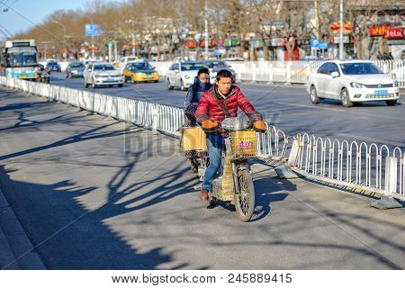 Beijing, China - March 10, 2016: There Are Many Different Motorcycles And Bicycles On The Streets Of
