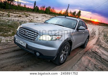 Novyy Urengoy, Russia - June 18, 2018: Grey Crossover Infiniti Fx35 At The Countryside At The Backgr