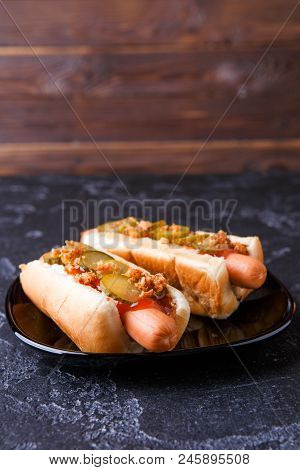 Photo Of Hotdogs On Black Plate At Table