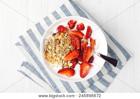 Healthy Breakfast With Granola, Yoghurt And Strawberry On The Table With Napkin. Top View With Place