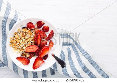Healthy Breakfast With Granola, Yoghurt And Strawberry On The Table With Napkin. Top View With Place