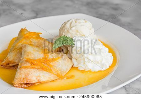 Crepes Suzette: French Thin Pancake With Orange Sauce And Ice Cream