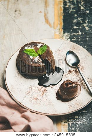 Hot Chocolate Souffle Dessert Cake With Liquid Filling And Chocolate Ice Cream Over Rustic Wooden Pa