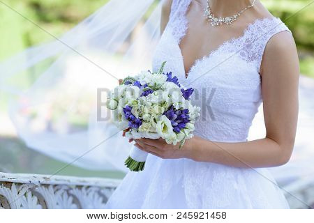 Beautiful Bride Is Holding A Wedding Colorful Bouquet. Beauty Of Colored Flowers. Close-up Bunch Of 