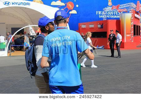 St. Petersburg, Russia - June 18, 2018: Fifa World Cup Russia 2018 Volunteer Helping A Fan. Voluntee